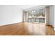 Bright living room with hardwood floors and sliding glass doors opening to a balcony at 455 Glen Iris Ne Dr # D, Atlanta, GA 30308