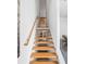 Modern staircase features wooden steps and handrail with white walls, providing a bright and airy feel at 455 Glen Iris Ne Dr # D, Atlanta, GA 30308