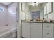 Bathroom featuring a tiled shower/tub and a vanity with granite counters at 1050 Wedgewood Ln, Tucker, GA 30084