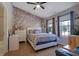Charming bedroom featuring brick accent wall, ceiling fan and hardwood flooring at 1050 Wedgewood Ln, Tucker, GA 30084
