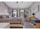 Well-lit bedroom featuring hardwood floors, two windows and brick accent wall at 1050 Wedgewood Ln, Tucker, GA 30084