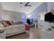 Comfortable bedroom featuring a ceiling fan, hardwood floors, and ensuite bathroom at 1050 Wedgewood Ln, Tucker, GA 30084
