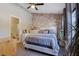 Charming bedroom featuring brick accent wall, ceiling fan and hardwood flooring at 1050 Wedgewood Ln, Tucker, GA 30084