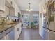 Bright kitchen with white cabinets, stainless steel appliances, and a view to the backyard at 1050 Wedgewood Ln, Tucker, GA 30084