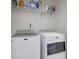 Laundry room with washer and dryer hookups and built-in storage shelf at 1050 Wedgewood Ln, Tucker, GA 30084