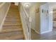 Staircase with carpeted steps and white railing with entry view at 1050 Wedgewood Ln, Tucker, GA 30084