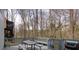 A spacious back deck with a picnic table and a grill, surrounded by a wooded view at 1413 Eastbrooke Way, Marietta, GA 30066