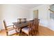 Dining room with a large table, six chairs, hardwood floors and wainscoting at 1413 Eastbrooke Way, Marietta, GA 30066