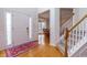 Inviting foyer featuring hardwood floors, staircase, and a view into the dining room at 1413 Eastbrooke Way, Marietta, GA 30066