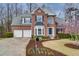 Charming two-story brick home featuring a two-car garage, manicured lawn and garden at 1413 Eastbrooke Way, Marietta, GA 30066