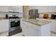 Well-appointed kitchen with stainless steel appliances, white cabinetry, and a granite island at 1413 Eastbrooke Way, Marietta, GA 30066