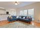 Cozy living room with a large sectional sofa, hardwood floors, and scenic backyard view at 1413 Eastbrooke Way, Marietta, GA 30066