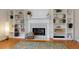 Bright living room featuring a fireplace with mantel, built-in shelving, and hardwood floors at 1413 Eastbrooke Way, Marietta, GA 30066