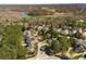 Community aerial view showcasing homes near the lake and scenic wooded surroundings at 5400 Saint Lyonn Pl, Marietta, GA 30068