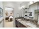 Bathroom vanity with double sinks, granite countertop, framed mirror, and neutral decor, leading to bedroom at 5400 Saint Lyonn Pl, Marietta, GA 30068
