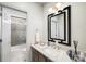 Contemporary bathroom with a marble countertop and modern mirror at 5400 Saint Lyonn Pl, Marietta, GA 30068