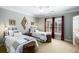 Bright bedroom featuring two twin beds, bedside tables, lamps, and a large window with shutters at 5400 Saint Lyonn Pl, Marietta, GA 30068
