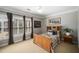 Bedroom featuring light-colored walls, light-colored carpet, plantation shutters, ceiling fan, and modern furniture at 5400 Saint Lyonn Pl, Marietta, GA 30068