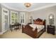 Charming bedroom with a dark wood bed frame, stylish desk, and bright windows at 5400 Saint Lyonn Pl, Marietta, GA 30068