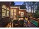 Outdoor dining area on a wooden deck, overlooking the backyard with a partial view of the pool at 5400 Saint Lyonn Pl, Marietta, GA 30068