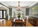 Dining room with hardwood floors, a large dining table, and a classic chandelier fixture at 5400 Saint Lyonn Pl, Marietta, GA 30068