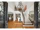Grand foyer showcasing high ceilings, hardwood floors, a staircase, and elegant chandelier at 5400 Saint Lyonn Pl, Marietta, GA 30068