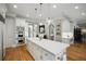 Expansive kitchen with an oversized island, stainless appliances, double ovens and hardwood floors at 5400 Saint Lyonn Pl, Marietta, GA 30068