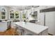 Bright kitchen boasts stainless steel appliances, hardwood floors, and a large center island with seating at 5400 Saint Lyonn Pl, Marietta, GA 30068