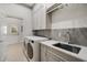 Functional laundry room with modern appliances, gray cabinetry, and a utility sink at 5400 Saint Lyonn Pl, Marietta, GA 30068