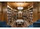 Elegant library with custom wood bookshelves and decorative lighting at 5400 Saint Lyonn Pl, Marietta, GA 30068