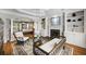Inviting living room with a fireplace, built-in shelves, and a view of the main bedroom at 5400 Saint Lyonn Pl, Marietta, GA 30068