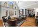 Bright living room with high ceilings, large windows, hardwood floors, and an open floor plan at 5400 Saint Lyonn Pl, Marietta, GA 30068