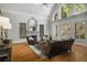Cozy living room features hardwood floors, a fireplace, and large windows at 5400 Saint Lyonn Pl, Marietta, GA 30068