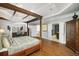 Elegant main bedroom with hardwood floors and a four-poster bed connected to the living area at 5400 Saint Lyonn Pl, Marietta, GA 30068
