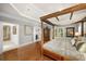 Open main bedroom with hardwood floors, a canopy bed, and views of the adjacent hallway at 5400 Saint Lyonn Pl, Marietta, GA 30068