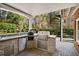 Outdoor kitchen with granite countertops, grill, and spiral staircase access at 5400 Saint Lyonn Pl, Marietta, GA 30068