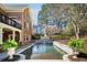 Backyard swimming pool and waterfall feature surrounded by lush greenery for a private oasis at 5400 Saint Lyonn Pl, Marietta, GA 30068
