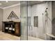 Modern walk-in shower with multiple shower heads, built-in shelving, glass doors, and unique tile accents at 5400 Saint Lyonn Pl, Marietta, GA 30068