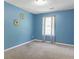 Serene bedroom with blue walls, neutral carpet, a large window, and minimalist decor at 7158 Georges Way, Morrow, GA 30260