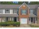 Charming townhome with brick accents, well-maintained landscaping, and an attached one car garage at 7158 Georges Way, Morrow, GA 30260
