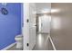 A clean and bright powder room featuring blue accent wall, modern fixtures, and neutral decor at 7158 Georges Way, Morrow, GA 30260
