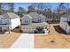 Aerial view of a two-story home with a welcoming front porch and spacious driveway at 1784 Treymire Ct, Stone Mountain, GA 30088