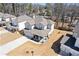 An aerial view showcases a charming home with a covered porch and landscaped surroundings at 1784 Treymire Ct, Stone Mountain, GA 30088
