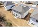 Aerial view of the rear of the home with a back patio and seating at 1784 Treymire Ct, Stone Mountain, GA 30088