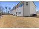 Large backyard featuring a patio area with chairs and manicured landscaping at 1784 Treymire Ct, Stone Mountain, GA 30088