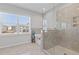 Bright bathroom showcasing glass shower, soaking tub, and natural light from window at 1784 Treymire Ct, Stone Mountain, GA 30088