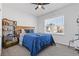 Cozy bedroom with a ceiling fan and a window letting in natural light at 1784 Treymire Ct, Stone Mountain, GA 30088