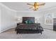 Elegant bedroom with a black bed frame, soft carpet, and crown molding at 1784 Treymire Ct, Stone Mountain, GA 30088