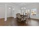 The dining room features dark wood flooring, white trim, a modern light fixture, and a table with upholstered chairs at 1784 Treymire Ct, Stone Mountain, GA 30088
