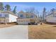 Inviting two-story home featuring a covered porch with seating and a well-manicured lawn at 1784 Treymire Ct, Stone Mountain, GA 30088